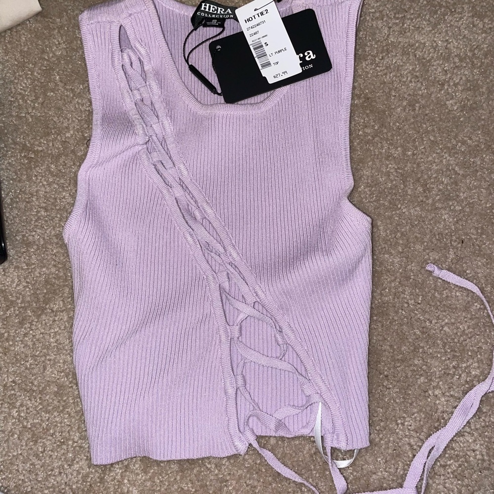 Wearing the same shirt in a different color (purple is the one for sale)